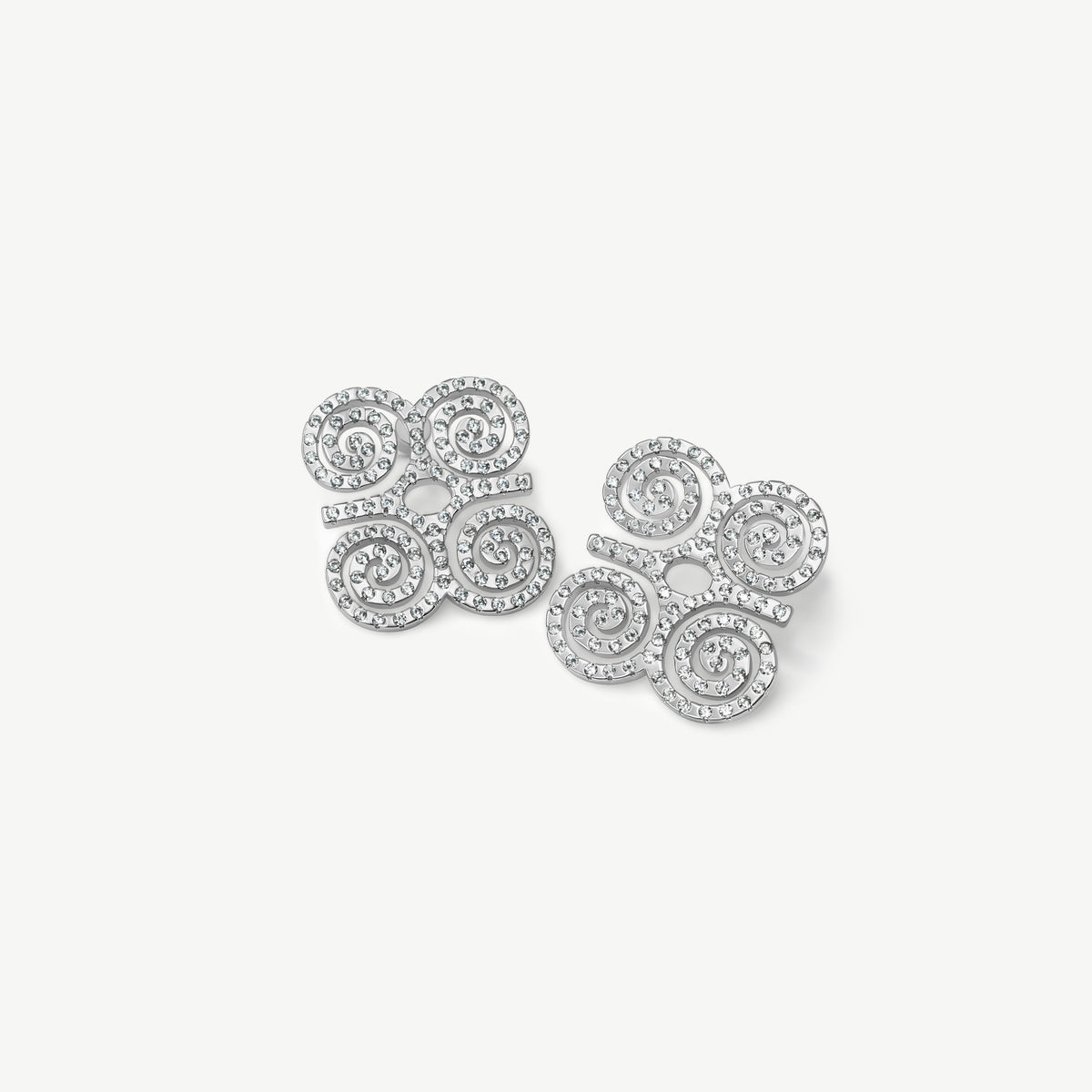 A high-resolution product shot of CASA London's silver Dwennimmen Pavé Stud Earrings. The pair features the intricate Adinkra symbol of rams' horns, representing strength and humility, meticulously encrusted with shimmering pavé-set stones. Set against a minimalist white background, the design highlights the brand's commitment to merging historic West African artistry with sophisticated, modern luxury.